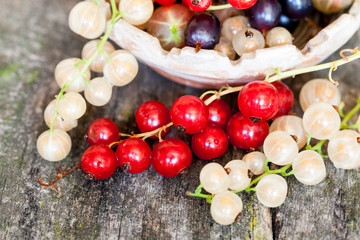Currants, cherries and other summer fruits with old wood texture