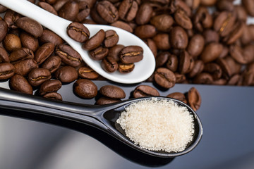 Coffee beans, brown sugar and small teaspoons