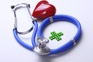 Green medical cross sign stethoscope red heart