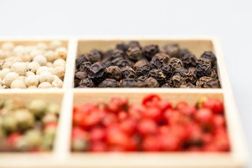 Different types of pepper: red, green dark and white