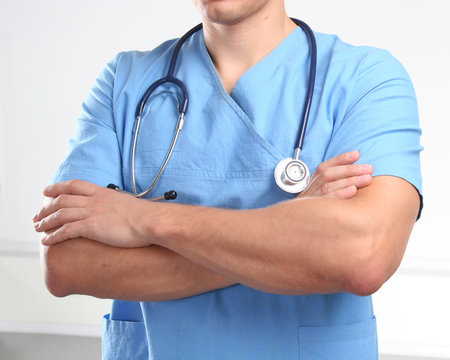 Closeup of man doctor in blue uniform with stethoscope