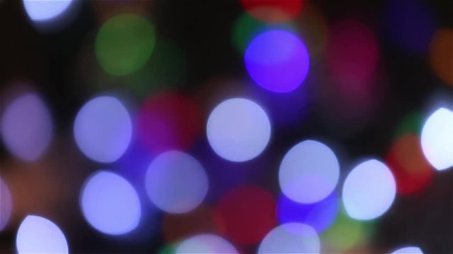 Blue, green, red, colorful blurred, bokeh lights background. Abstract sparkles. Christmas garlands