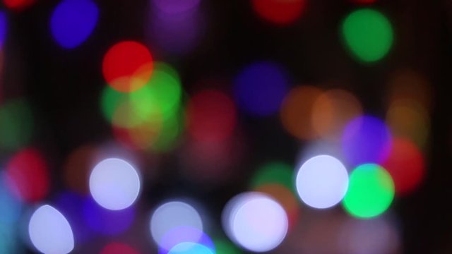 Blue, green, red, colorful blurred, bokeh lights background. Abstract sparkles. Christmas garlands
