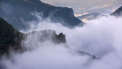 Mountain landscape with dense fog in motion
