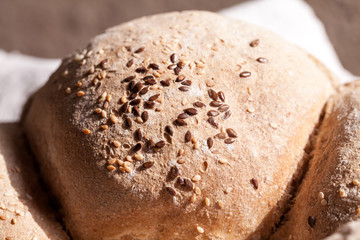 Organic home made bread with flax seeds and rural background