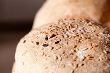 Organic home made bread with flax seeds and rural background