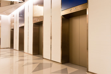 four elevators in hotel lobby.