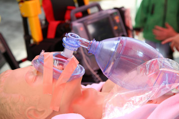 Practicing to use an oxygen mask on training doll