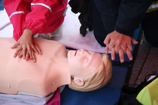 Practicing CPR chest compressioon on a dummy
