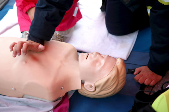 Practicing CPR chest compressioon on a dummy