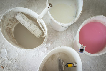 Metal buckets with colorful paint on