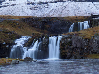 Scenic Kirkjufellsfoss waterfall in early winter, Snaefellsness Peninsula in Iceland