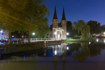 Eastern Gate, Oostpoort, with the white draw bridge, along Delftse Schie canal at night, Delft, Holland, Netherlands