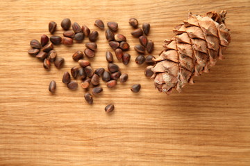 Walnut and pine nuts on a cutting board made of oak/ Walnut and pine nuts on a cutting board made of oak
