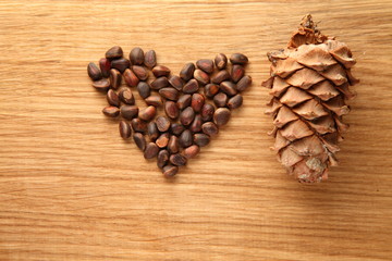 Walnut and pine nuts on a cutting board made of oak/ Walnut and pine nuts on a cutting board made of oak