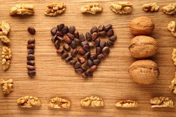 Walnut and pine nuts on a cutting board made of oak/ Walnut and pine nuts on a cutting board made of oak