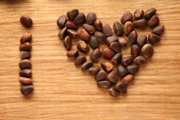 Walnut and pine nuts on a cutting board made of oak/ Walnut and pine nuts on a cutting board made of oak