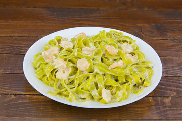 delicious green tagliatelle isolated on white