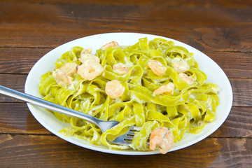 delicious green tagliatelle isolated on white