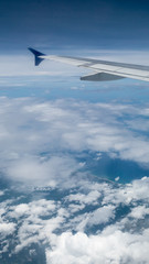 Fototapeta na wymiar The airplane wing on the beautiful cloudy and sky.