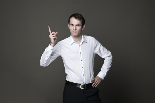Young businessman with red tie laughing in studio