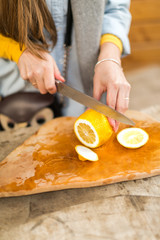 the girl cuts lemon.