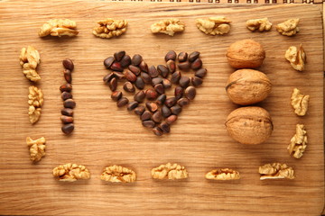 Walnut and pine nuts on a cutting board made of oak/ Walnut and pine nuts on a cutting board made of oak