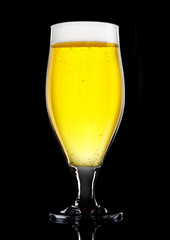 Glass of beer cider with foam golden color  black