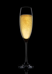 Glass of sparkling champagne with bubbles on black