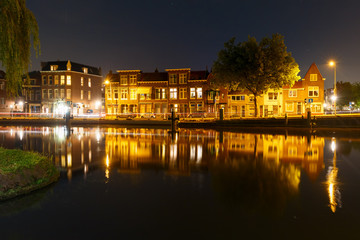 Fototapeta na wymiar Night canal and typical dutch houses with their reflections in Delft, Holland, Netherlands