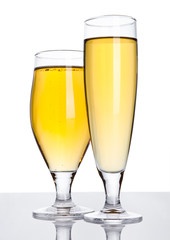 Glasses of beer cider with foam golden color white