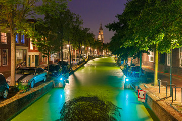 Night Oosteinde canal and Gothic Protestant Nieuwe Kerk, New church in Delft, Holland, Netherlands