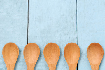 Wooden spoon on blue wood floors.