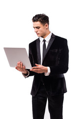 Portrait of smiling young businessman with laptop isolated over white background.