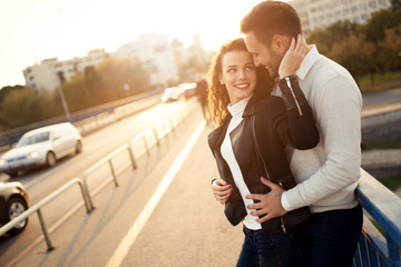 Beautiful couple hugging in city