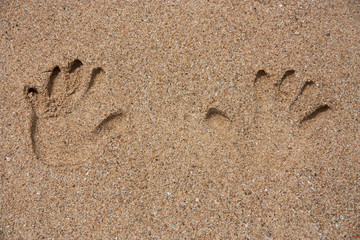Hands print on the sand