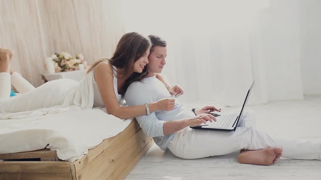 young couple with laptop and card. Online shopping