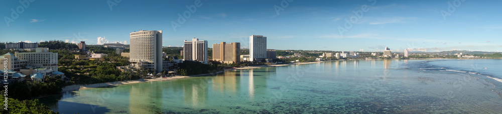 Wall mural beautiful sunset beach and buildings in guam