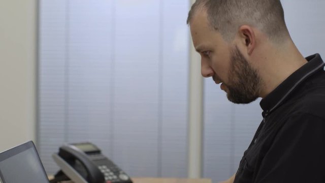 A man checking his online account and celebrating winning to camera