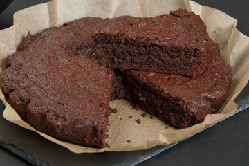 Homebaked Chocolate Brownie In Parchment Paper. Slate Stone.