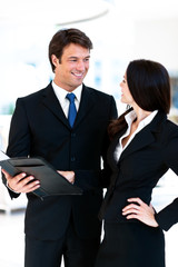 Businesswoman and Businessman in Lobby