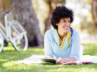 Young woman using tablet in the park.