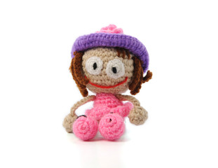 Knitted small handmade doll on white background