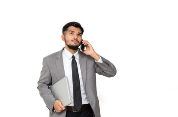 Asian businessman using smartphone while holding laptop isolated on white background