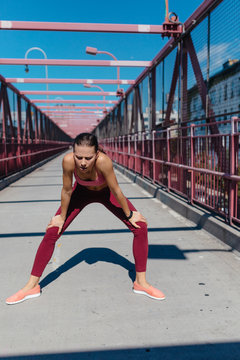 Young Woman Taking A Break after a Run . Williamsburg Bridge Brooklyn NYC