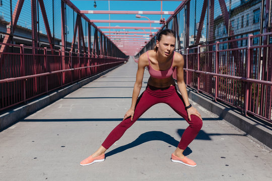 Young Woman Taking A Break after a Run . Williamsburg Bridge Brooklyn NYC