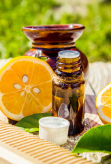 lemon essential oil and lemon fruit on the wooden board, (taken with tilt shift lens). 