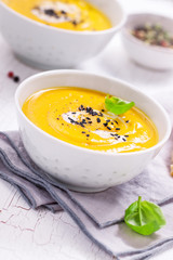 Homemade vegetable soup with pumpkin with cream and black sesame, closeup