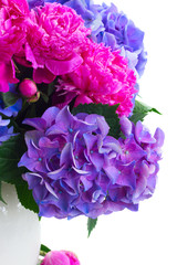 Bright pink peony and blue hortensia fresh flowers bouquet close up isolated on white background