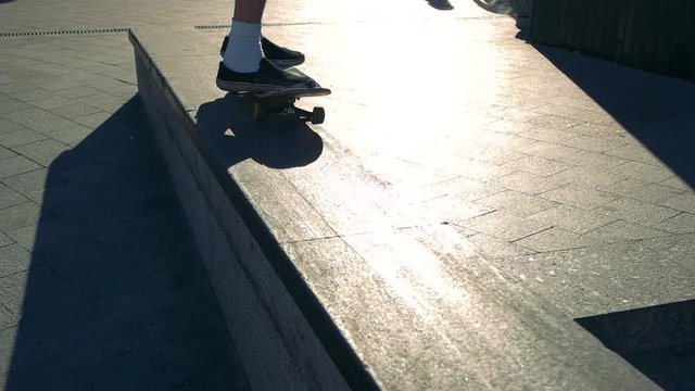 Feet on a skateboard. Trick of skateboarder. Perfect 50-50 grind. Maintain speed and balance.